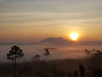 Scenic view of silhouette mountains against sky during sunset