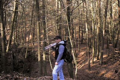 Portrait of man standing in forest