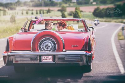 Rear view of a couple on road