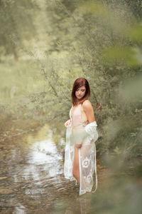 Full length of woman standing in lake