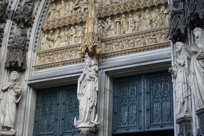 Low angle view of statue against historic building