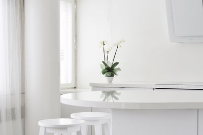 White flower vase on table at home