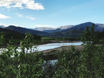 Scenic view of lake and mountains against sky