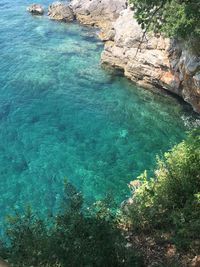 High angle view of rocks by sea