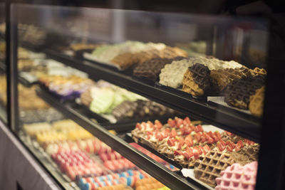 Various sweet food in display cabinet for sale at store