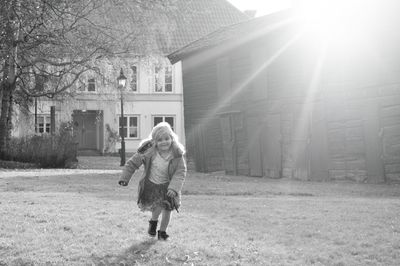 Full length of cute girl running on land during sunny day