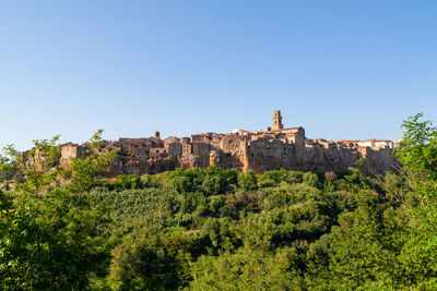 Little beautiful medieval town pitigliano in tuscany, italy against blue sky