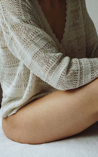 Midsection of woman sitting on floor