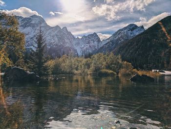 Scenic view of lake and mountains against sky