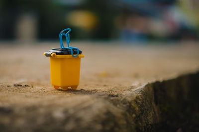 Close-up of drink on retaining wall