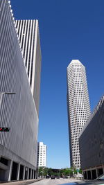 Low angle view of skyscrapers against clear blue sky