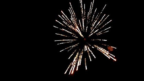 Low angle view of firework display at night