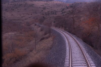 View of railroad tracks by mountain