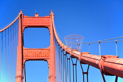 Low angle view of bridge against clear blue sky