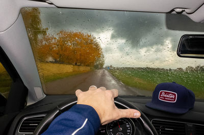 Man seen through car window