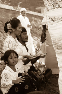 Rear view of people with arms raised