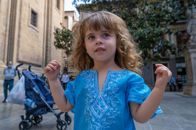 Beautiful blonde girl in arab costumes posing for camera in the streets of granada, spain