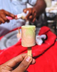 Close-up of hand holding ice cream