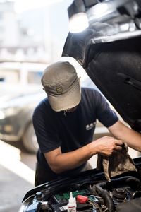 Close-up of man working on motorcycle