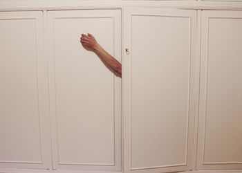 Midsection of man holding door