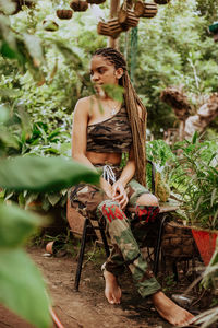 Woman standing by tree trunk