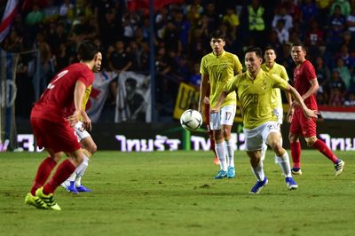 Group of people playing soccer on field