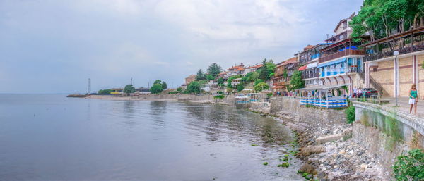 Panoramic view of sea and buildings against sky