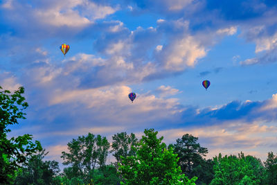 Low angle view of hot air balloons against sky during sunset