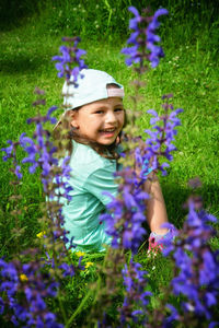 Portrait of a smiling girl with purple flowers