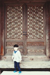 Full length of man sitting by door