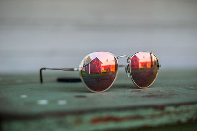 Close-up of sunglasses on water against sky