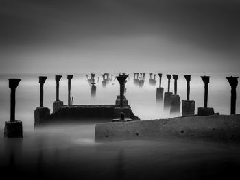 Broken pier in sea against sky in calicut city