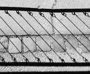 High angle view of shadow on railing