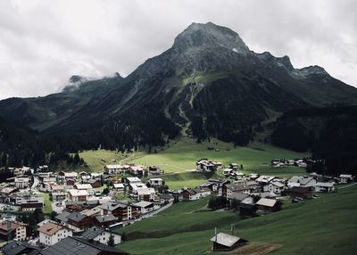 Scenic view of houses and mountains against sky