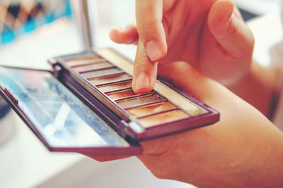 Close-up of woman applying make up