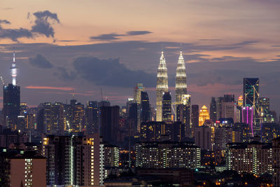 Skyscrapers in city at dusk