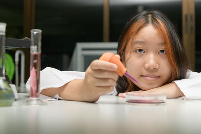 Girl scientist using dropper with rubber test. education and science concept