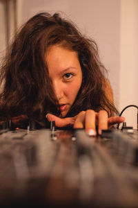 Close-up of fashionable young woman playing music at home