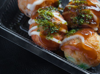 Close-up of takoyaki in container on table