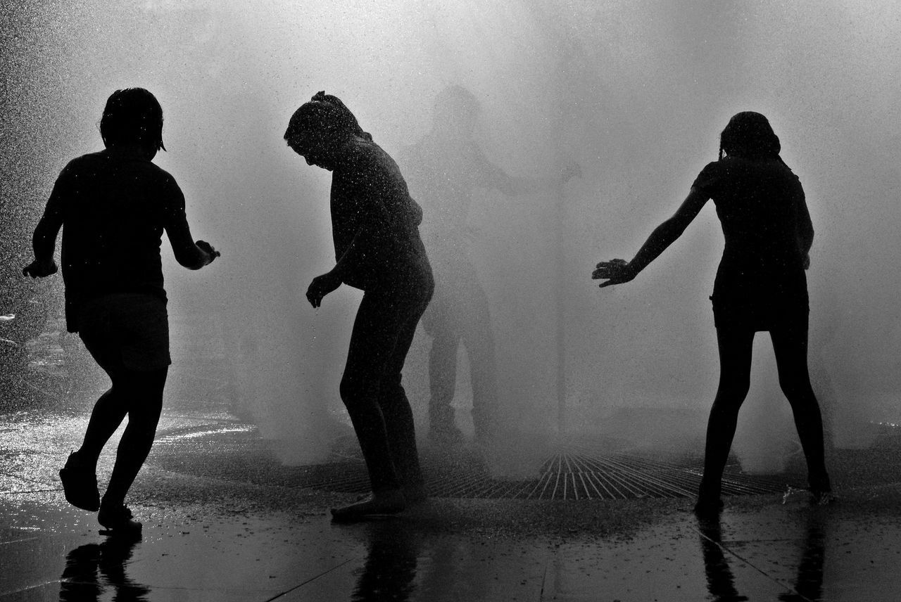 black and white, black, silhouette, fog, water, monochrome photography, monochrome, group of people, darkness, full length, wet, men, adult, shadow, small group of people, lifestyles, women, nature, person, child, modern dance, togetherness