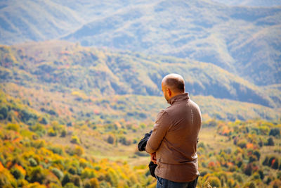 Rear view of man standing on mountain