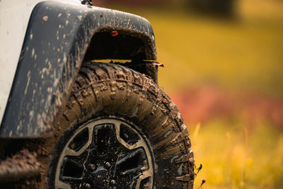 Close-up of abandoned car on field