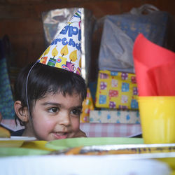 Close-up of boy wearing party hat at home