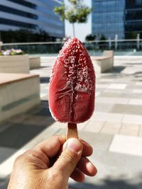 Close-up of hand holding flavored ice