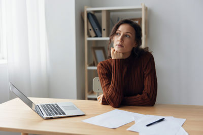 Portrait of young businesswoman working at office