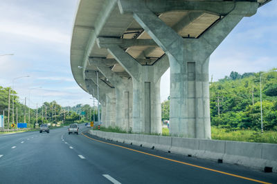 Road by bridge against sky