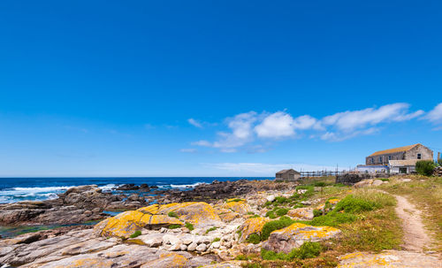 Scenic view of sea and buildings against sky