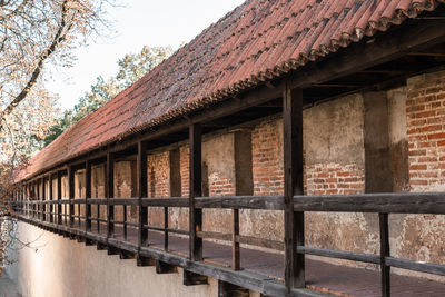 Exterior of old building by trees against sky