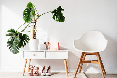 Stylish room interior with elegant dressing table and monstera plants