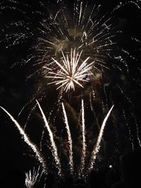 Low angle view of firework display at night